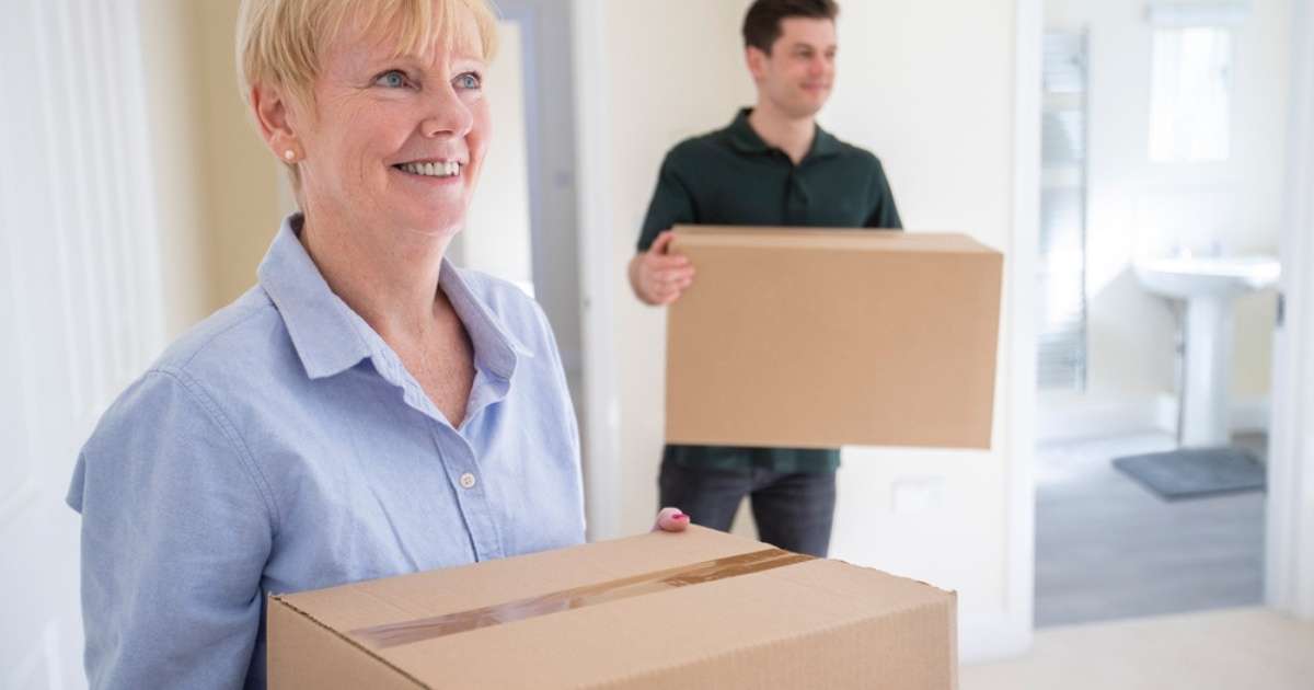 A Greenville senior with her son holding boxes